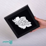 🇮🇷✨ تابلو طرح «علاج در وطن است»؛ ترکیبی از هویت، هنر و اصالت ایرانی این تابلو زیبا، دقیقاً همان نقطه‌ای است که هنر مدرن با ریشه‌های اصیل ایرانی گره می‌خورد. تابلو طرح «علاج در وطن است» با استفاده از نقشه ایران و خوشنویسی درهم‌تنیده، به شکلی ظریف پیام هویت‌دوستی و وطن‌گرایی را در قالب یک اثر هنری ارائه می‌دهد. جنس اصلی اثر از چوب باکیفیت است و بخش مرکزی — نقشه ایران — از پلکسی آینه‌ای ساخته شده؛ همین ترکیب باعث ایجاد درخشش چشمگیر در نور می‌شود و اثر را برای قرار گرفتن روی میز، شلف یا دیوار به گزینه‌ای متمایز تبدیل می‌کند ✨. این تابلو با ابعاد استاندارد 22×22 سانتی‌متر، و وزن تنها 55 گرم، کاملاً مناسب پک‌های فرهنگی مدارس، یادبودهای دهه فجر، نمایشگاه‌های مناسبتی و هدیه‌های سازمانی است. سبکی این محصول باعث می‌شود حمل‌ونقل، بسته‌بندی و استفاده از آن بسیار ساده و کاربردی باشد. 📌 مشخصات فنی و ویژگی‌ها: 📏 ابعاد: 22 × 22 سانتی‌متر ⚖️ وزن: 55 گرم (فوق‌العاده سبک) 🪵 جنس فریم: چوب با پوشش مات 🪞 جنس نقشه: پلکسی آینه‌ای با برش دقیق 🎨 نقش مرکزی: نقشه ایران با خوشنویسی زیبای ایرانی 🇮🇷 مناسب برای: دهه فجر، هدایای دانش‌آموزی، دکور اتاق و میز کار اگر به دنبال هدیه‌ای فرهنگی، زیبا و در عین حال کاربردی هستید، این تابلو می‌تواند یک انتخاب کاملاً ماندگار باشد — هدیه‌ای که حضورش زیبایی فضا را دو چندان می‌کند ✨🌿.